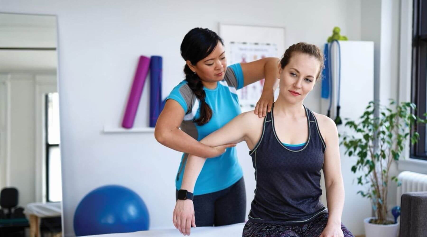 woman shoulder stretch by PT