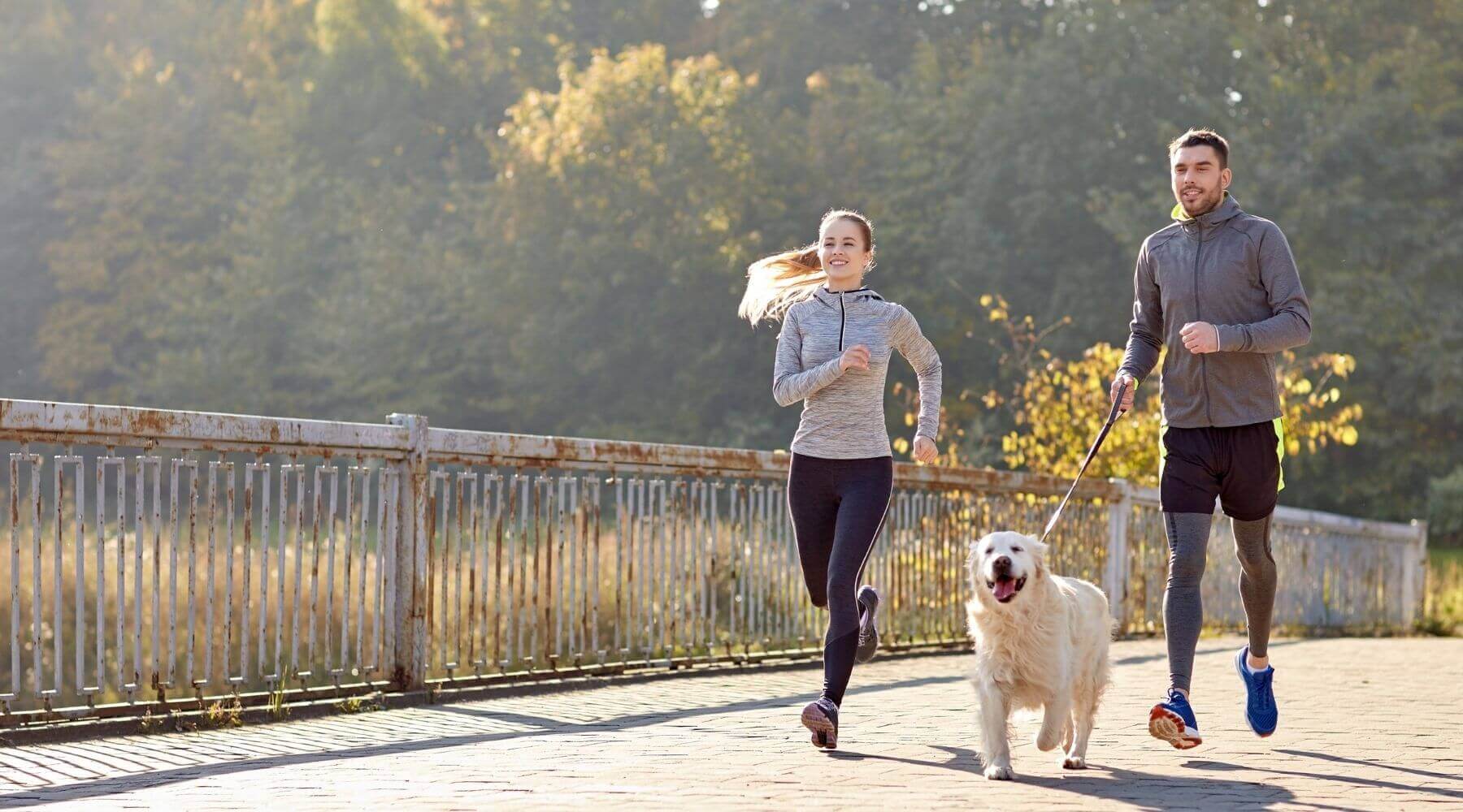 Young Couple running with dog