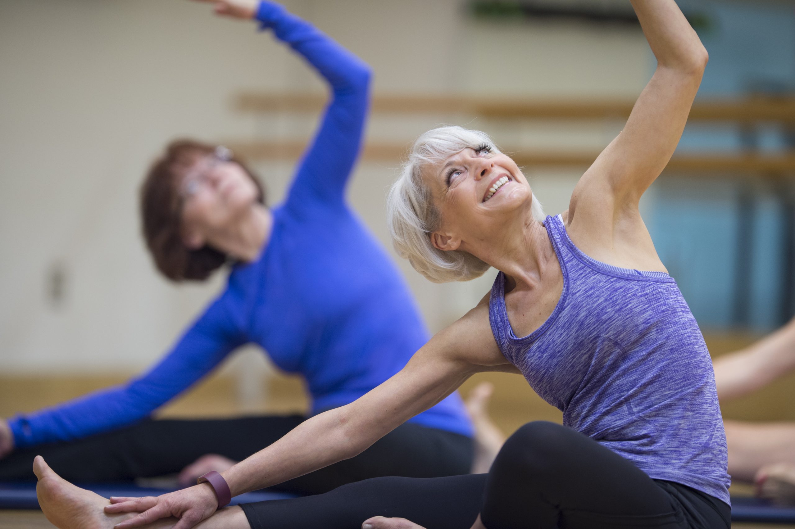 Older and younger woman doing yoga pose