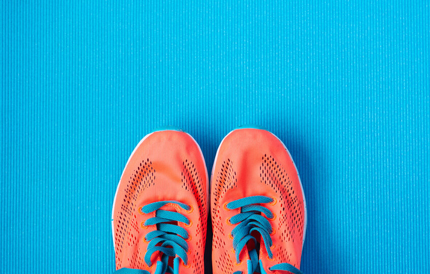 orange running shows on the gym floor