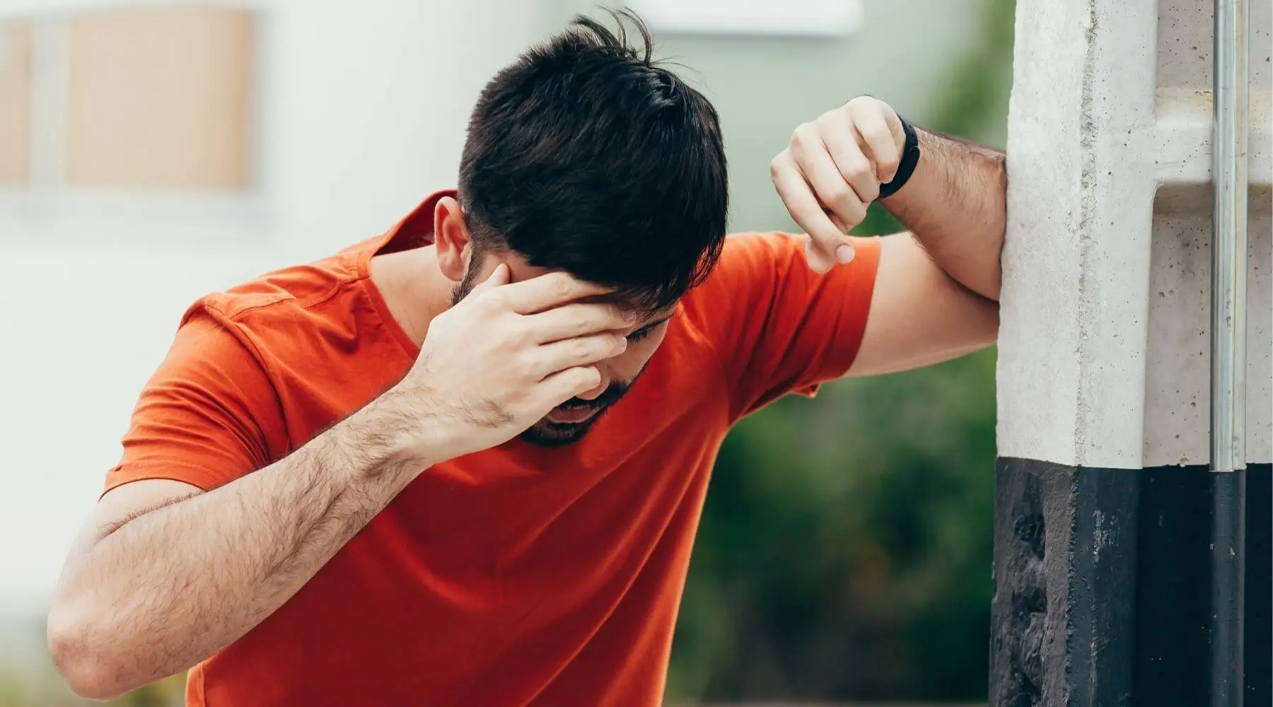 Male red shirt holding head