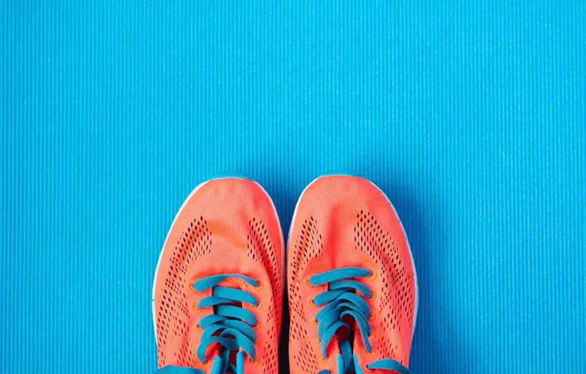 orange running shows on the gym floor