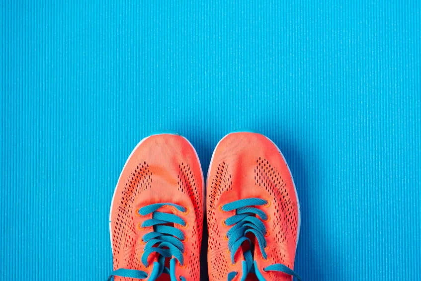 orange running shows on the gym floor