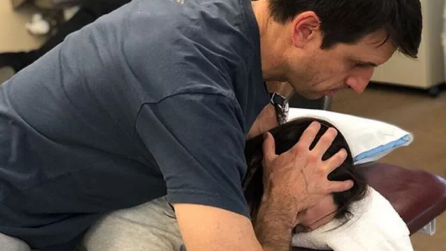 A ProRehab Physical Therapist performs a neck adjustment on a patient.