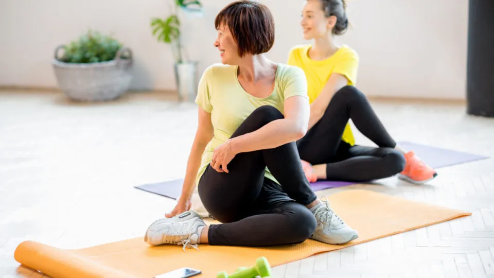 Young and older women doing yoga
